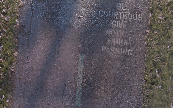 Screen shot of orthophoto showing readable text: "Be courteous give notice when passing"