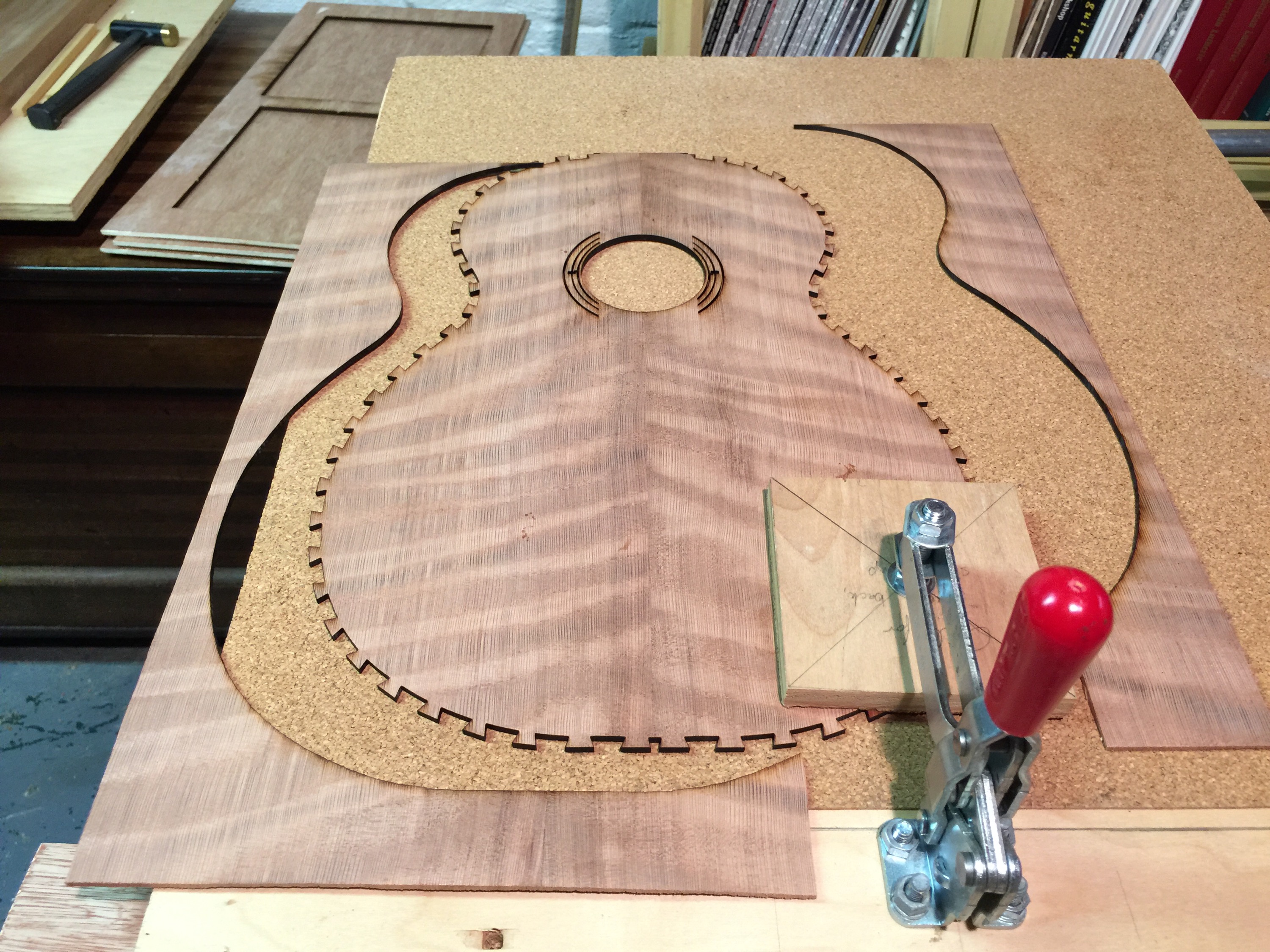 Here is the follow up on the curly redwood top for the tenor guitar. I went to Cleveland Public Library, where they have a laser engraver in the basement to do some really outlandish cuts -- here some non-sensical dovetails, and a stopped rosette.