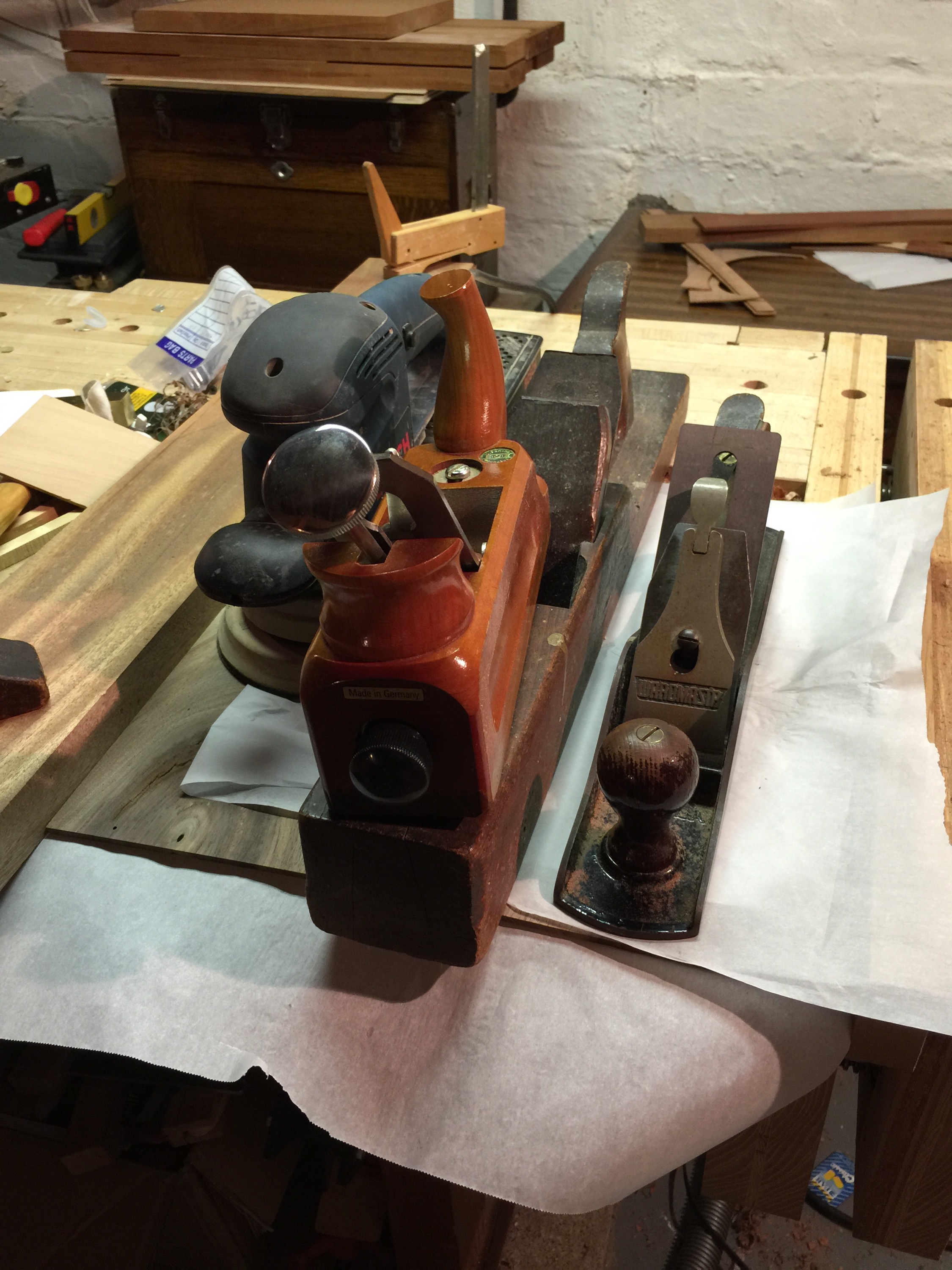 Sometimes you clamp boards down with whatever is on hand. In this case, it's most of my smoothing tools... an EC Emmerich smoothing plane, a Stanley knock off, a nice big 22 inch wooden plane, and my random orbital sander.