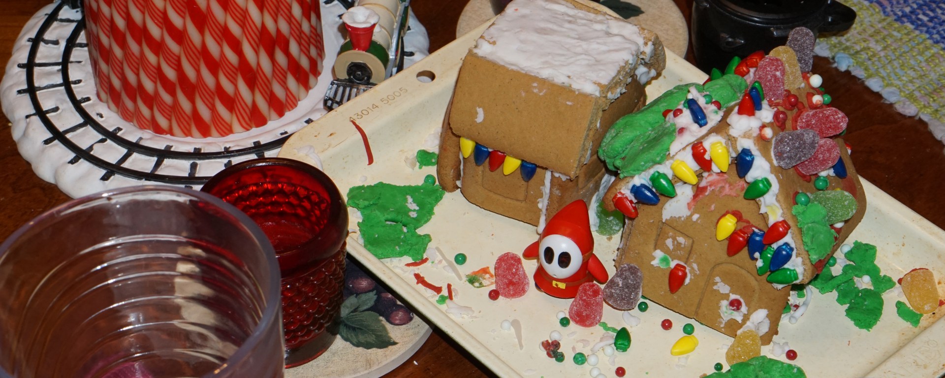 Image of dining room table with gingerbread house centerpiece and candles