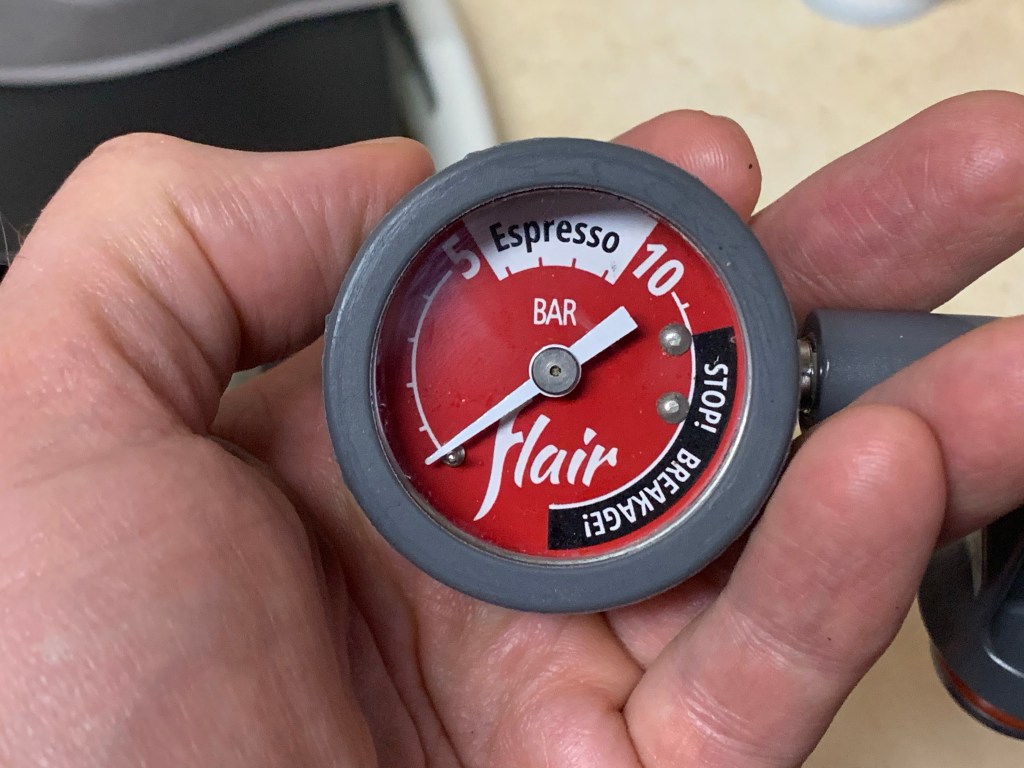 Image of Flair Espresso Gauge being held in hand.