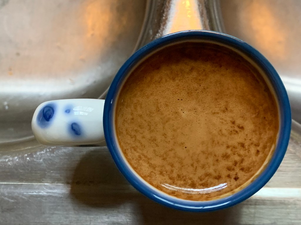 Image of top of demitasse with nicely striped espresso crema in full view.