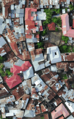 Animation showing panning across aerial photograph of city, then across a digital elevation model of that city and the nearby coastline